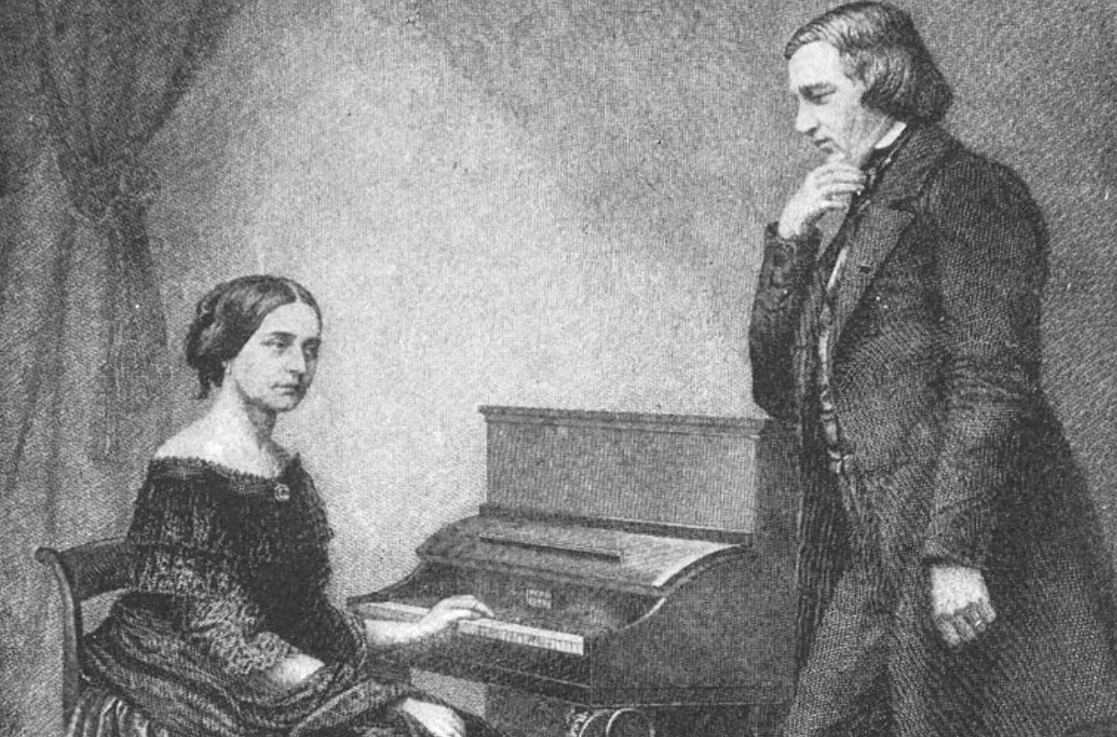 A black and white illustration shows a woman seated at a piano, looking ahead, while a man stands beside her, observing thoughtfully. Both are dressed in 19th-century attire, and a curtain is visible in the background.