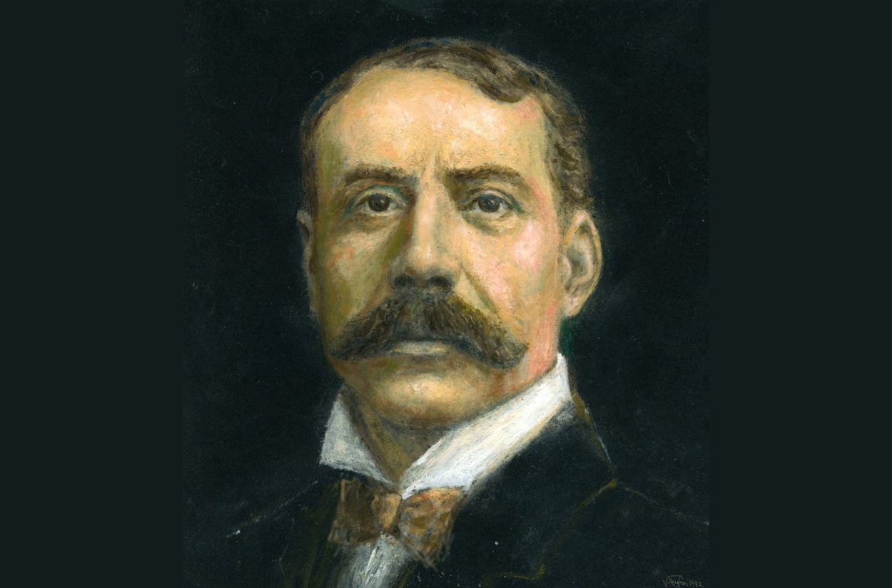 A formal portrait painting of a man with short hair and a large moustache, wearing a high-collared shirt and bow tie. The background is dark, highlighting the subject’s face and formal attire.