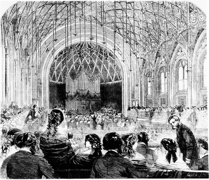 Black and white illustration of a grand concert hall with a large pipe organ at the back. An orchestra and choir perform on stage, surrounded by an audience sitting in tiered seating under a vaulted, ornate ceiling.