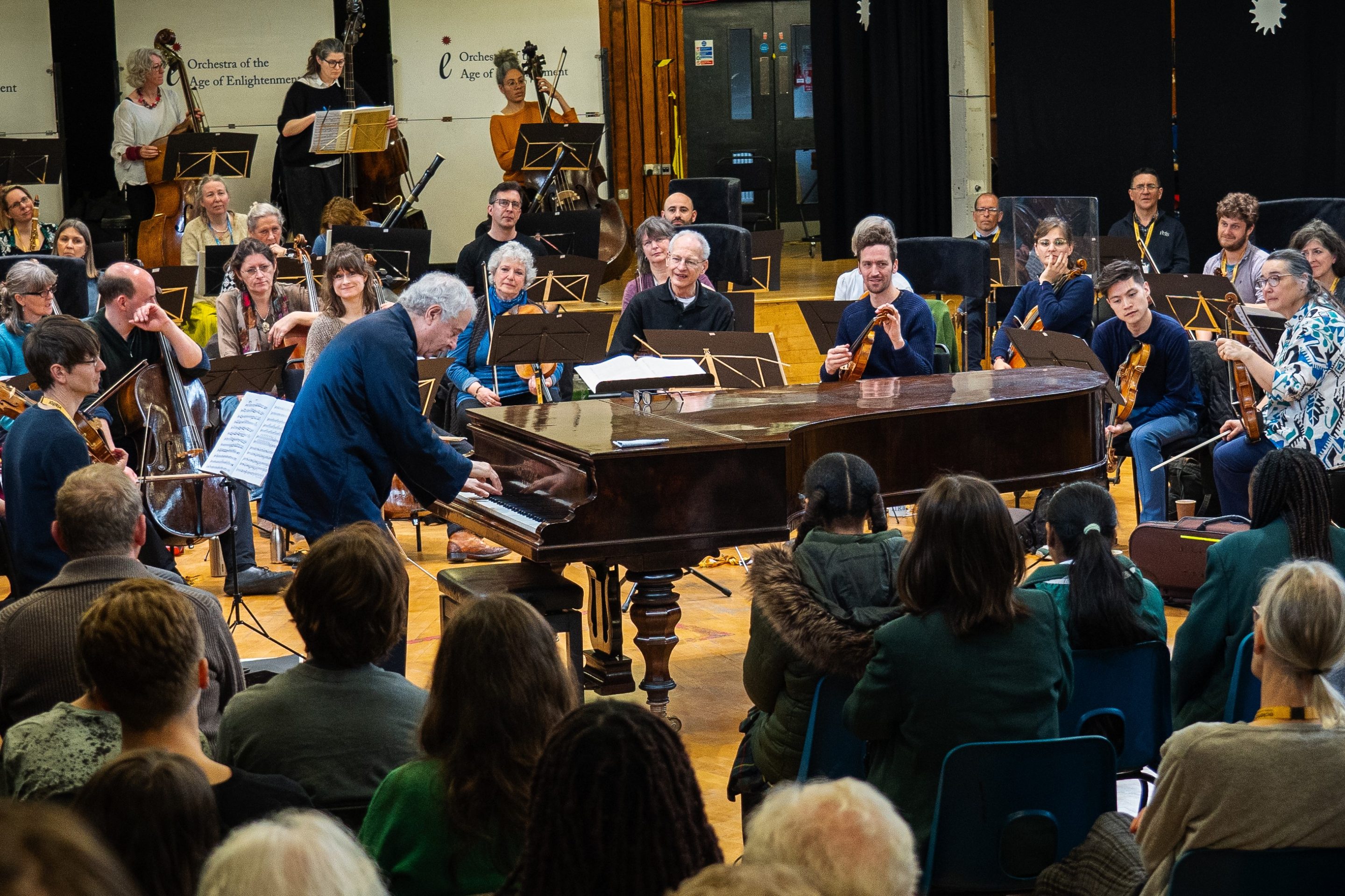 Pianist Andras Schiff demonstrates on a piano during a community open rehearsal for school students and members of the public