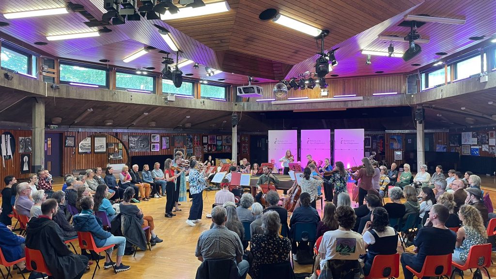 The OAE Experience ensemble, a group of early career musicians, performing to a community audience in the Assembly Hall at Acland Burghley School